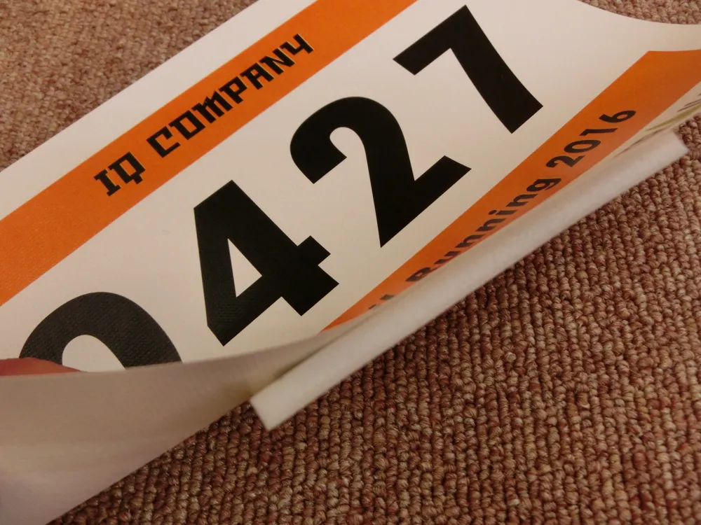 A disposable timing chip stuck on the back of a race bib